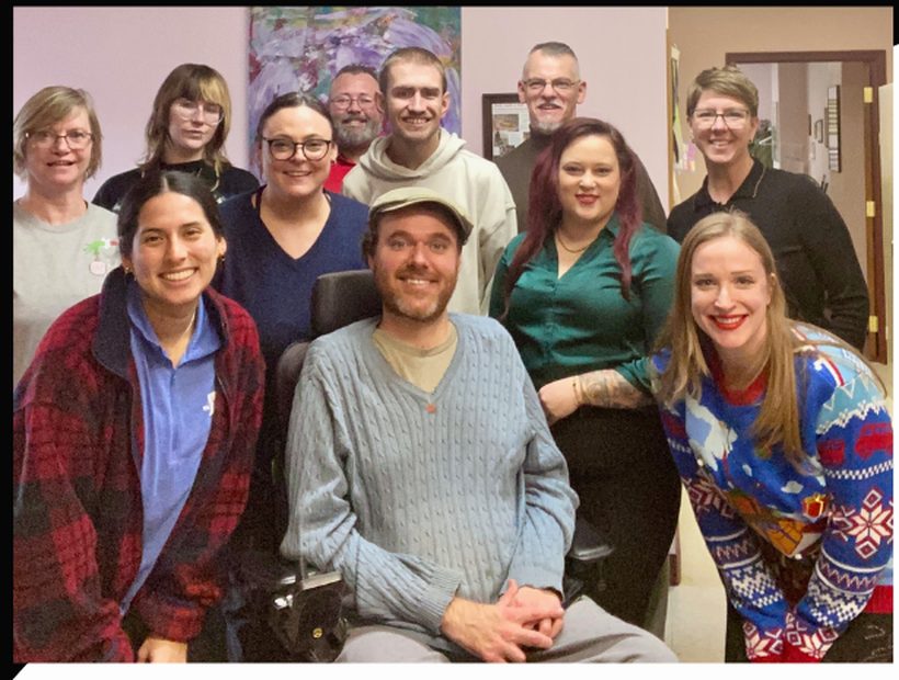 The SOCIL team: a group of staff members smiling together indoors.