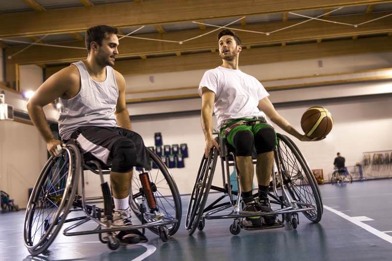 Two athletes playing wheelchair basketball
