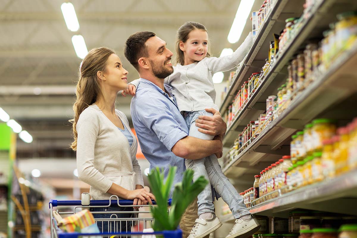 A family shopping together in a grocery store aisle