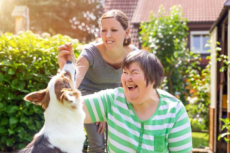 student and teacher washing dog